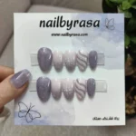 ناخن مصنوعی راسا فرم بادامی رنگ یاسی و نقره‌ای طرح برف و بافت زمستانی مدل RSN0488